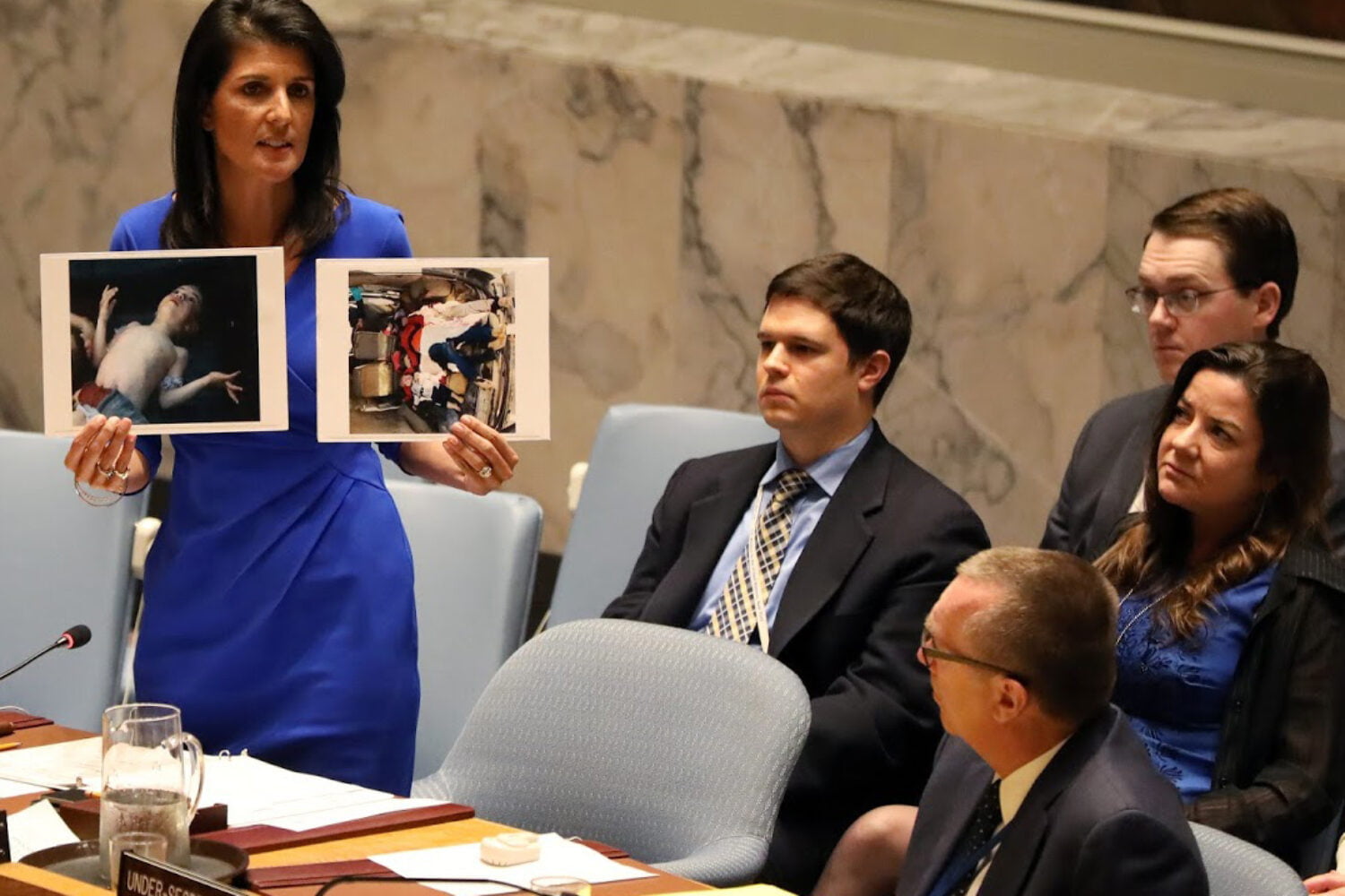 U.S. Ambassador to the United Nations Nikki Haley holds photographs of victims during a meeting at the United Nations Security Council on Syria at the United Nations Headquarters in New York City, NY, U.S. April 5, 2017. REUTERS/Shannon Stapleton FOR EDITORIAL USE ONLY. NO RESALES. NO ARCHIVES     TPX IMAGES OF THE DAY