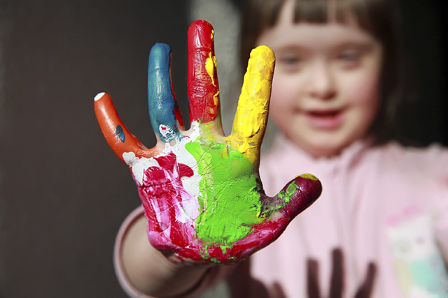 Cute little girl with painted hand