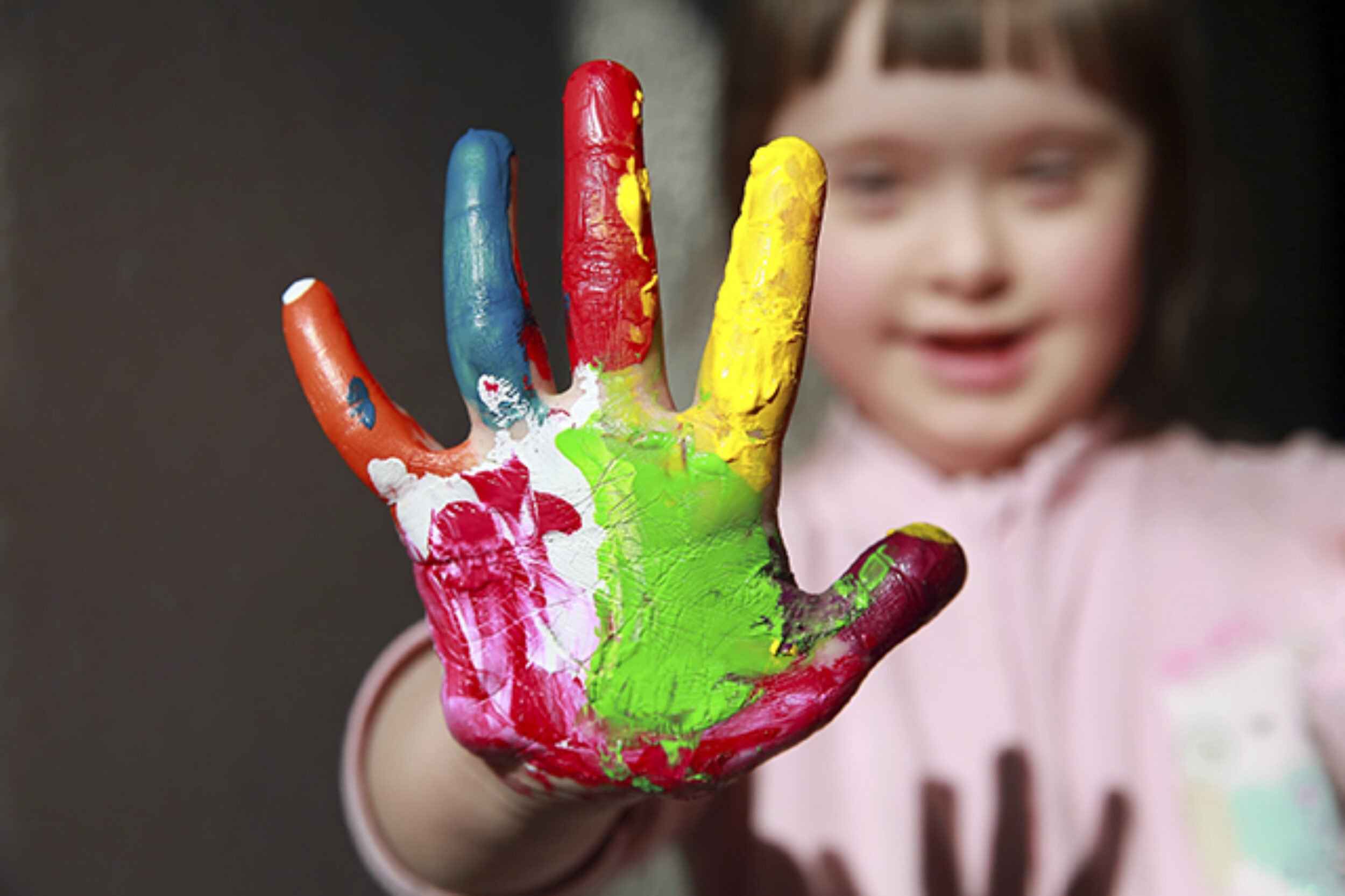 Cute little girl with painted hand