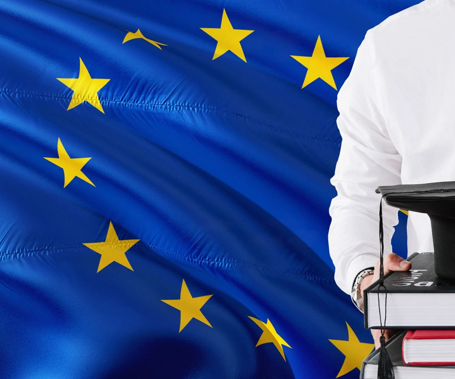 Successful European student education concept. Holding books and graduation cap over European Union flag background.